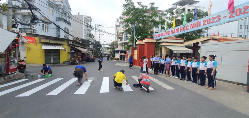Trường THCS An Nhơn phối hợp với Đoàn Phường 6, Công An Phường 6 thực hiện quét dọn và sơn sửa trước cổng trường.